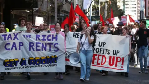 Getty Images People march through Sydney in a housing rally