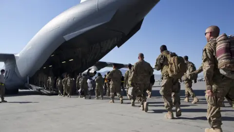 Getty Images US soldiers walk to their C-17 cargo plane for departure May 11, 2013 at Bagram Air Base, Afghanistan