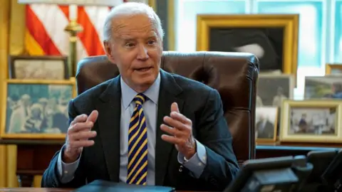 U.S. President Joe Biden answers questions from the media at a briefing on the federal response to the wildfires across Los Angeles, in the Oval Office at the White House in Washington, U.S., January 10, 2025. 