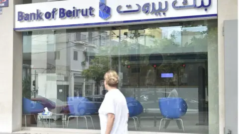 Getty Images Man walks in front of branch of Bank of Beirut