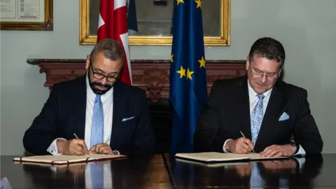 European Commission James Cleverly and Maros Sefcovic signing paperwork to ratify the Windsor Framework