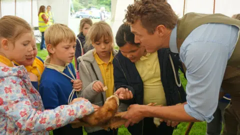 Glendale Agricultural Show  A group of children stroke a ferret