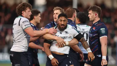 Bundee Aki is held by Duhan van der Merwe