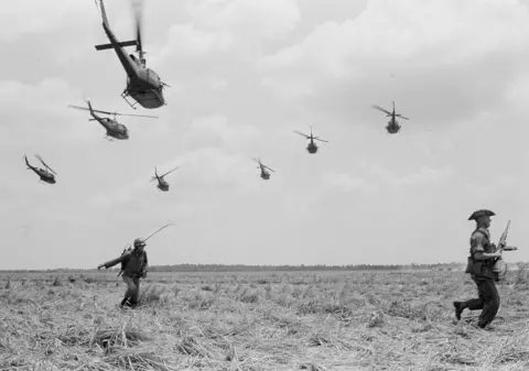AP Photo/Peter Arnett/File U.S. Army helicopters take off after dropping South Vietnamese rangers on parched rice paddy for an assault on red positions south of Vi Thanh, March 27, 1965