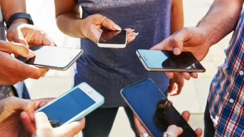 Getty Images People holding mobile phones