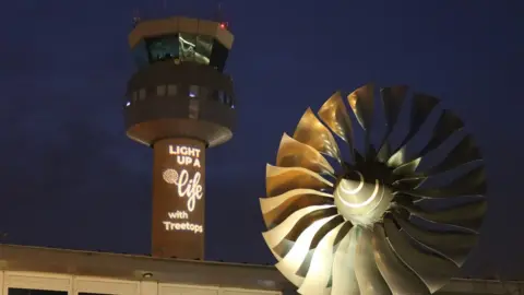 Air traffic control tower displaying hospice Christmas appeal message