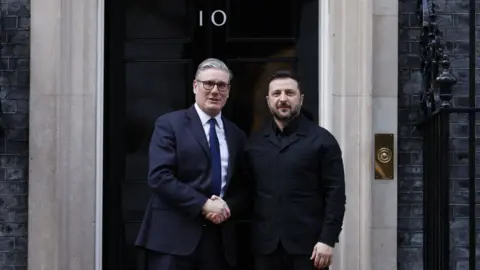 EPA/Shutterstock Prime Minister Keir Starmer (L) greets Ukrainian President Volodymyr Zelensky (R) in Downing Street, London. Zelensky is wearing a black jacket as he shakes the hand of Starmer who is wearing a navy suit and white shirt