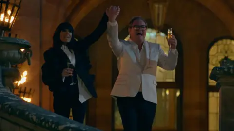 Alan Carr and Claudia Winkleman celebrating his win