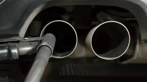 Getty Images A hose for an emission test is fixed in the exhaust pipe of a Volkswagen Golf 2 litre diesel car at the Technical Inspection Agency in Ludwigsburg, southwestern Germany, on August 7, 2017