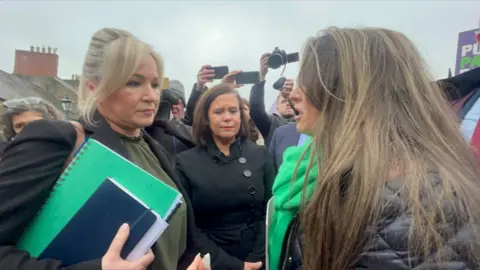 Claudia Savage/PA Stephanie Greenwood of Unison speaks to Michelle O'Neill about public sector pay on the way into the talks