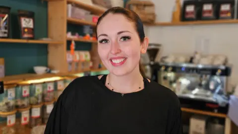 Paul Moseley/BBC Charlotte Spendlove in a cafe