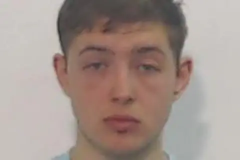 Police Scotland A mugshot of a young man with brown hair