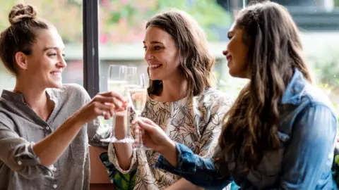 Getty Images Three women drinking alcohol