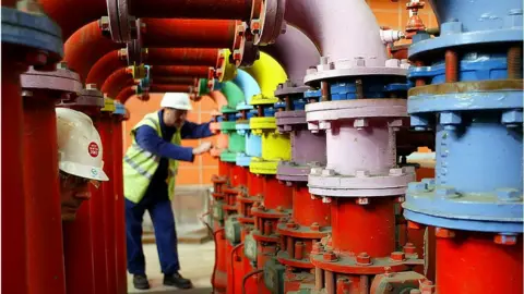 Getty Images EDF employees John Wilkinson (L) and Alan Green (R) next to turbine fire protection at EDF central electrique of West Burton