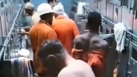 Skin and Coal/ Claudine Booth Miners undressing for the shower