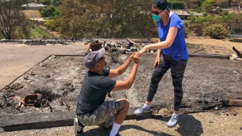 Mike Eliason/Santa Barbara County Fire Department Mr Rao proposes again to his wife in the ashes of their home