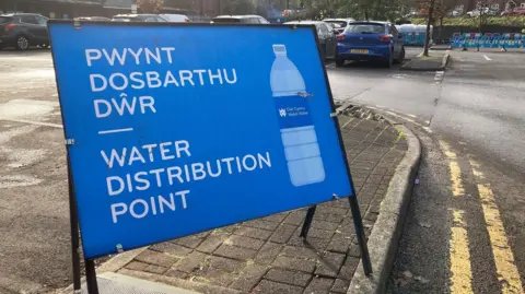 BBC A sign saying Water Distribution Point at the Co-op car park in Treorchy, Rhondda Cynon Taf.