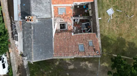 Aerial view of a house damaged in an incident in Jersey