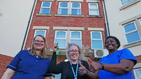 NAvigo Staff with the keys to Tees House