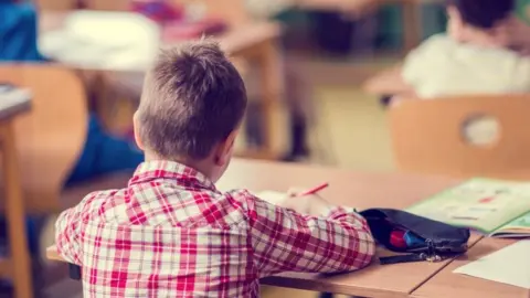 Getty Images Child sitting in a classroom