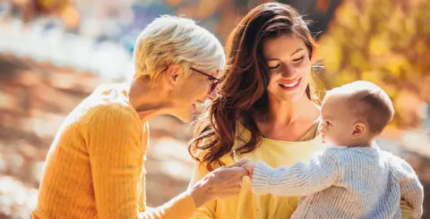 Getty Images Two women with a baby