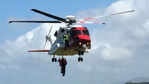 HM Coastguard Sikorsky helicopter in action over Caernarfon, Gwynedd