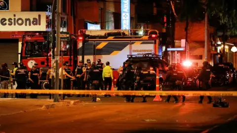 Reuters Police officers work outside the rally site where Ecuadorean presidential candidate Fernando Villavicencio was killed at a campaign event in Quito, Ecuador August 9, 2023.