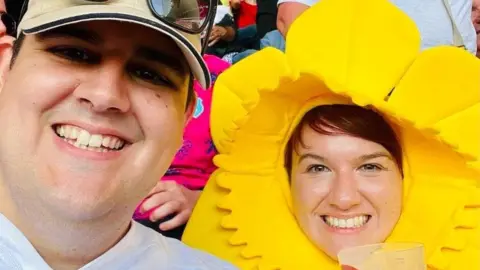 Clare Ervine Paddy and Clare Ervine watching Wales v Portugal, with Clare wearing a daffodil hat