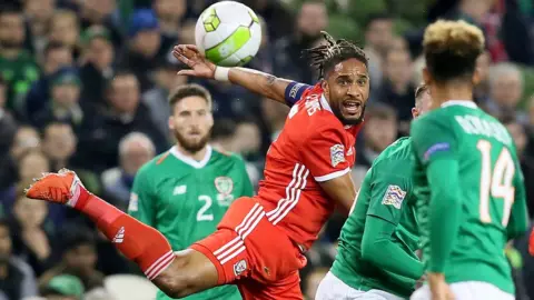 AFP | Getty Images Ashley Williams in action in the air during Tuesday's game