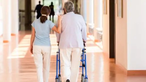 Getty Images Carer with woman