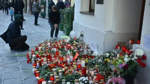 Getty Images Flowers and candles are placed during a commemorative ceremony held on 5 Nov 2020 for four people killed in a terror attack in Vienna