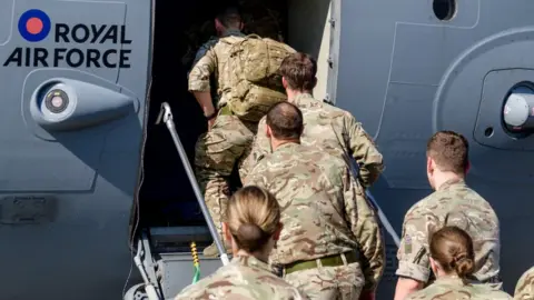 Cpl Timothy Jones Military personnel board an RAF aircraft