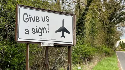 'Give us a sign' slogan on sign