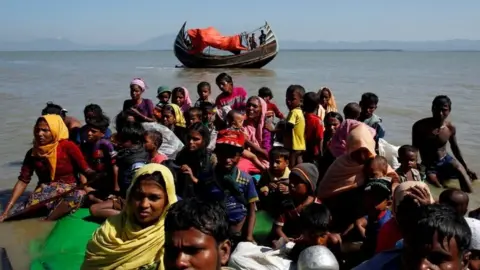 Reuters Rohingya refugees sit on a makeshift boat as they get interrogated by the Border Guard Bangladesh after crossing the Bangladesh-Myanmar border, at Shah Porir Dwip near Cox"s Bazar, Bangladesh