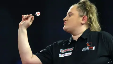 Beau Greaves prepares to throw a dart