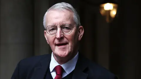 EPA Headshot of Hilary Benn wearing a suit and tie