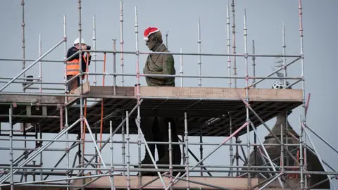The statue surrounded by large sections of scaffolding