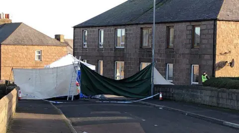 Police astatine  country   of decease  successful  Peterhead, constabulary  serviceman  lasting  extracurricular  house, thoroughfare  covered up   .