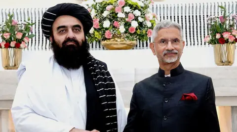 Indian Ministry of External Affairs / Handout via Getty Images Afghan Taliban Foreign Minister Amir Khan Muttaqi with Indian counterpart S Jaishankar