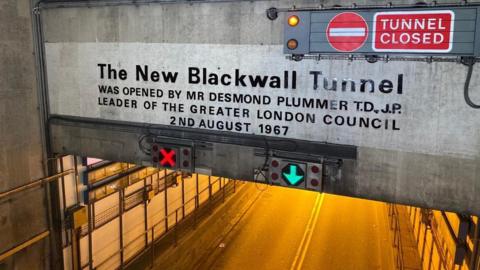 Blackwall Tunnel southbound entrance sign which says The New Blackwall Tunnel and has a red cross and green arrow indicating which lane is open
