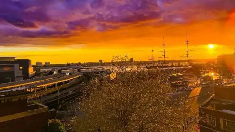 Portsmouth bathed in golden light with a purple sky