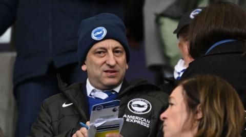 Brighton owner Tony Bloom in club hat and jacket