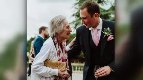 Sheila Lamb has a hand on her grandson Amos Waldman's shoulder on his wedding day.