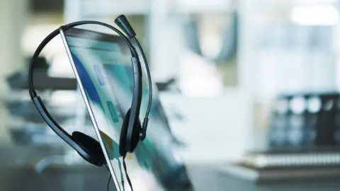 A generic image of a phone headset on a computer monitor.
