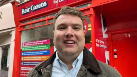 Andrew Turner/BBC Keir Cozens outside his campaign office on Broad Row, Great Yarmouth