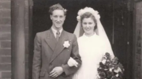 Family A black and white photograph of a man and woman getting married.
