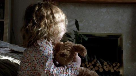 A child holding a teddy bear