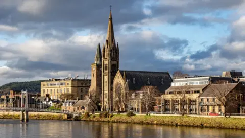 Getty Images An image of the city centre of Inverness, as seen across the River Ness, against a moody cloudy sky