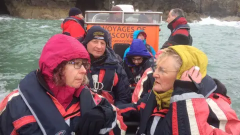 BBC Family members of Wladyslaw Kiedrzynski and Bertie Griffiths onboard a boat