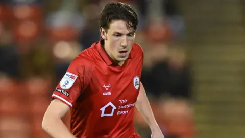 Mael de Gevigney in action for Barnsley against Wigan at Oakwell in March